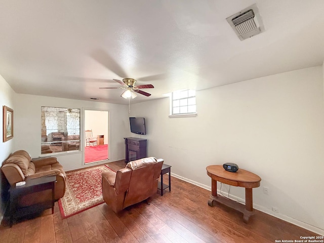 15430 S Main, Lytle, TX 78052 - living room with hardwood / wood-style floors, a ceiling fan, and baseboards