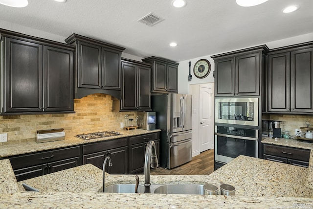 14042 Gemma, San Antonio, TX 78253 - kitchen featuring appliances with stainless steel finishes, wood finished floors, light stone countertops, and recessed lighting