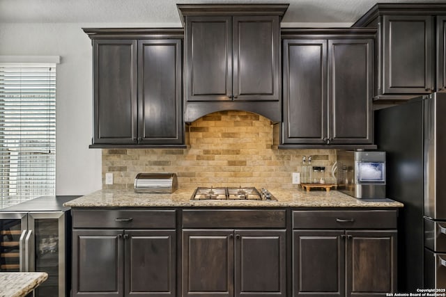 14042 Gemma, San Antonio, TX 78253 - kitchen featuring wine cooler, stainless steel appliances, decorative backsplash, light stone countertops, and dark brown cabinets