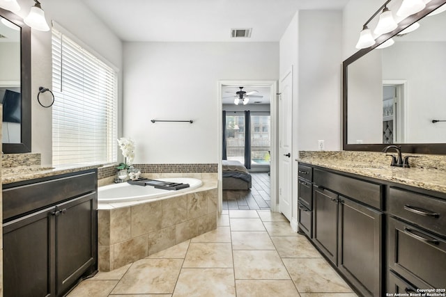 14042 Gemma, San Antonio, TX 78253 - ensuite bathroom featuring vanity, a garden tub, a ceiling fan, and tile patterned floors