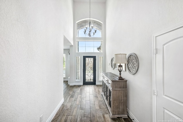 14042 Gemma, San Antonio, TX 78253 - foyer with a high ceiling, baseboards, a chandelier, and dark wood-type flooring
