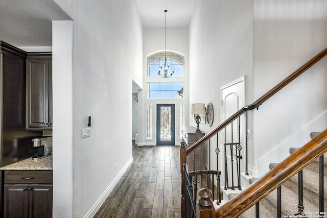 14042 Gemma, San Antonio, TX 78253 - foyer entrance with baseboards, a high ceiling, stairway, dark wood finished floors, and a chandelier