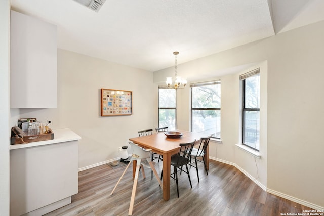 5535 Timber Cyn, San Antonio, TX 78250 - dining area with light wood-style floors, a chandelier, and baseboards
