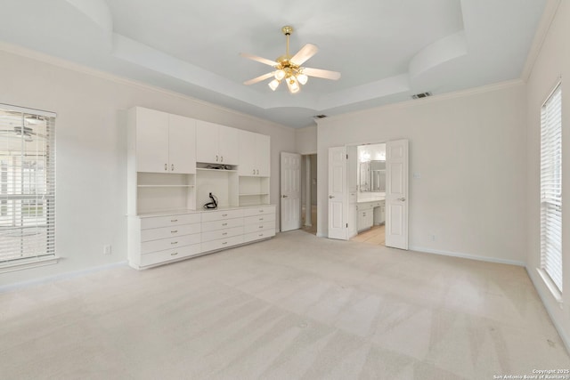 15618 Dawn Crst, San Antonio, TX 78248 - unfurnished bedroom featuring a tray ceiling, light colored carpet, baseboards, crown molding, and connected bathroom
