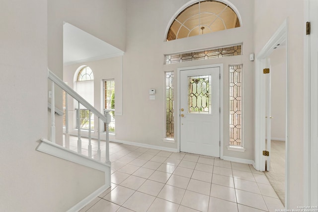 15618 Dawn Crst, San Antonio, TX 78248 - entrance foyer featuring baseboards, a towering ceiling, light tile patterned floors, and stairway