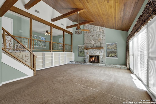 642 Lakebreeze, Canyon Lake, TX 78133 - unfurnished living room featuring a wood ceiling with exposed beams, carpet floors, ceiling fan, high vaulted ceiling, and a stone fireplace