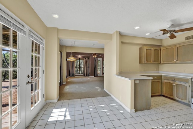 642 Lakebreeze, Canyon Lake, TX 78133 - kitchen featuring a ceiling fan, light countertops, french doors, light tile patterned floors, and light carpet