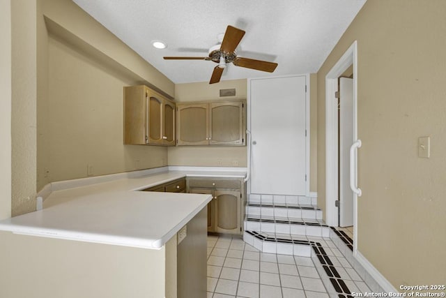 642 Lakebreeze, Canyon Lake, TX 78133 - kitchen featuring a peninsula, light countertops, ceiling fan, light tile patterned floors, and a textured ceiling