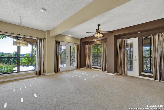 642 Lakebreeze, Canyon Lake, TX 78133 - empty room featuring a textured ceiling, french doors, carpet flooring, and a ceiling fan