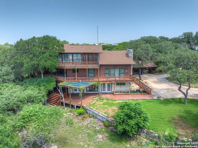 642 Lakebreeze, Canyon Lake, TX 78133 - rear view of house featuring stairway, a chimney, french doors, a deck, and a lawn