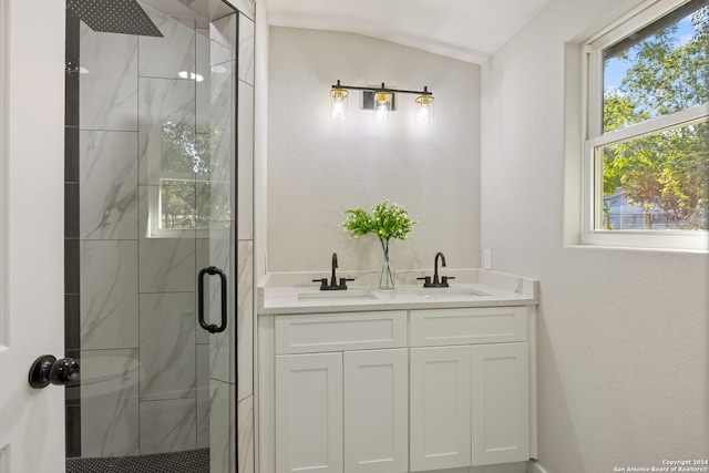 207 Northaven, San Antonio, TX 78229 - bathroom with a marble finish shower, vaulted ceiling, and double vanity
