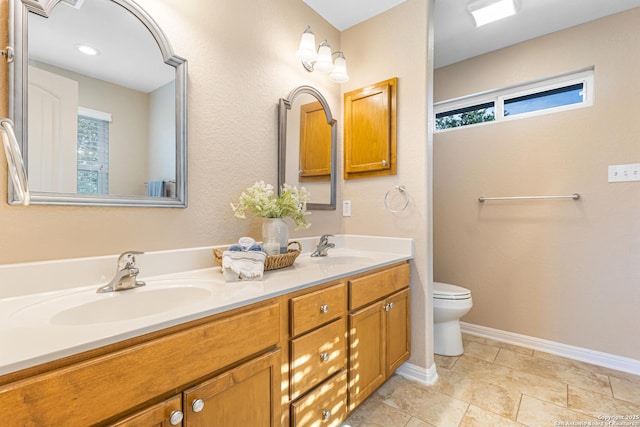 890 Live Oak, Spring Branch, TX 78070 - full bath featuring double vanity, plenty of natural light, toilet, and baseboards