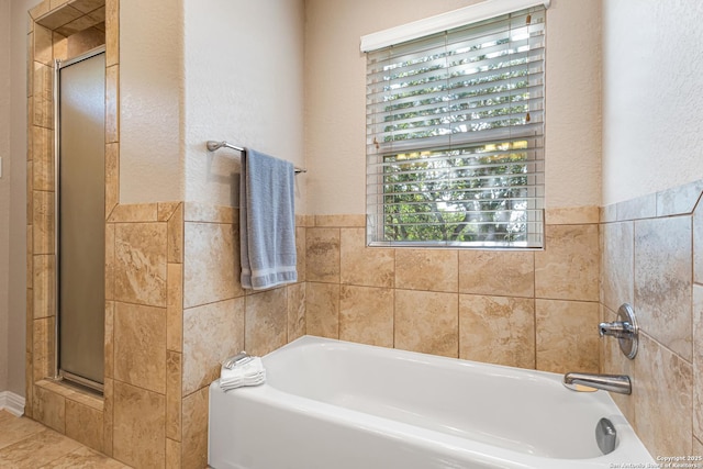 890 Live Oak, Spring Branch, TX 78070 - bathroom featuring a garden tub, plenty of natural light, a shower with shower door, and tile walls