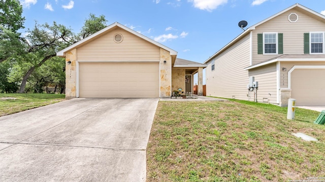 3714 Hideaway Grn, San Antonio, TX 78261 - view of front of home with stone siding, a front lawn, driveway, and an attached garage