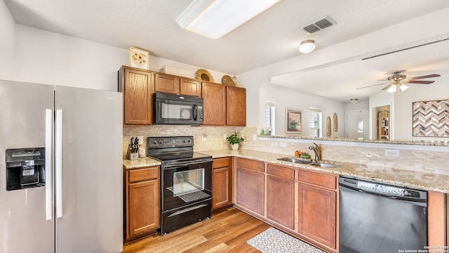 3714 Hideaway Grn, San Antonio, TX 78261 - kitchen featuring black appliances, a sink, tasteful backsplash, and light wood-style floors
