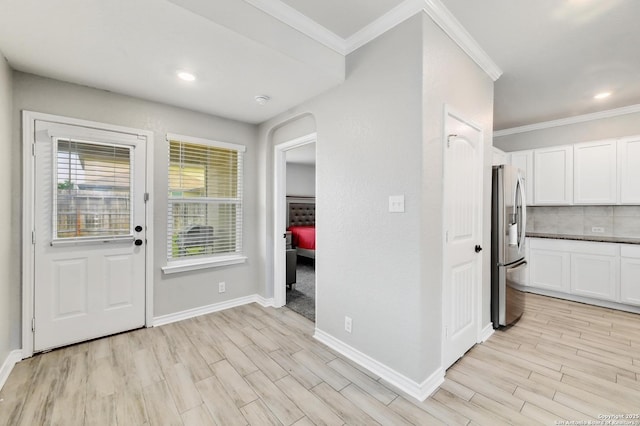 810 Brown Thrasher, San Antonio, TX 78253 - kitchen featuring stainless steel refrigerator with ice dispenser, light wood-style floors, white cabinetry, crown molding, and baseboards