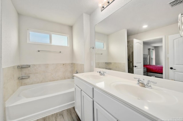 810 Brown Thrasher, San Antonio, TX 78253 - ensuite bathroom featuring a bath, double vanity, and wood finished floors