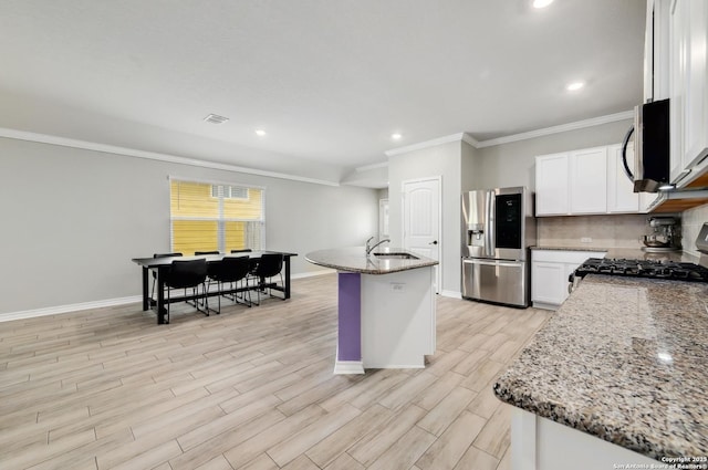 810 Brown Thrasher, San Antonio, TX 78253 - kitchen with stainless steel appliances, ornamental molding, stone counters, baseboards, and light wood-style flooring