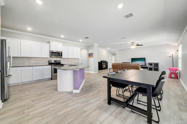 810 Brown Thrasher, San Antonio, TX 78253 - kitchen with appliances with stainless steel finishes, ornamental molding, backsplash, white cabinets, and baseboards