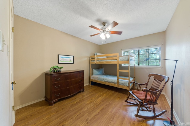 8735 Paseo Oaks, San Antonio, TX 78255 - bedroom featuring wood finished floors, baseboards, a textured ceiling, and ceiling fan