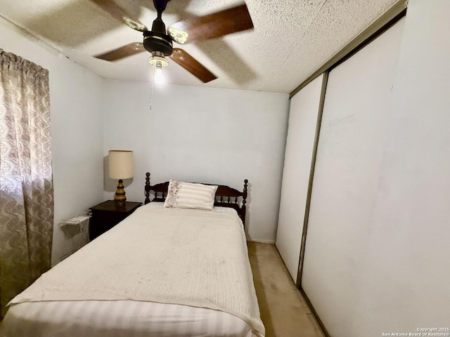 9010 Bowline, San Antonio, TX 78242 - bedroom with light carpet, a textured ceiling, a closet, and a ceiling fan
