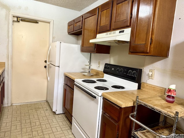 9010 Bowline, San Antonio, TX 78242 - kitchen with white range with electric stovetop, under cabinet range hood, light countertops, and brick patterned floors