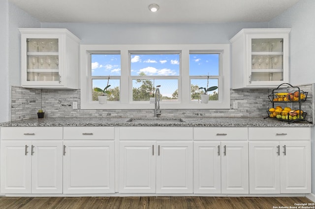 13040 Tomlynn, Atascosa, TX 78002 - kitchen featuring a sink, light stone countertops, backsplash, and white cabinetry