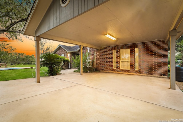 13040 Tomlynn, Atascosa, TX 78002 - patio terrace at dusk featuring a patio area and a carport