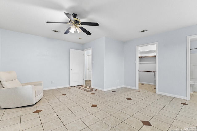 13040 Tomlynn, Atascosa, TX 78002 - bedroom with a walk in closet, baseboards, and a ceiling fan