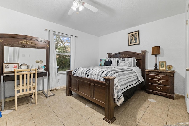 13040 Tomlynn, Atascosa, TX 78002 - bedroom featuring light tile patterned floors, a textured ceiling, baseboards, and a ceiling fan