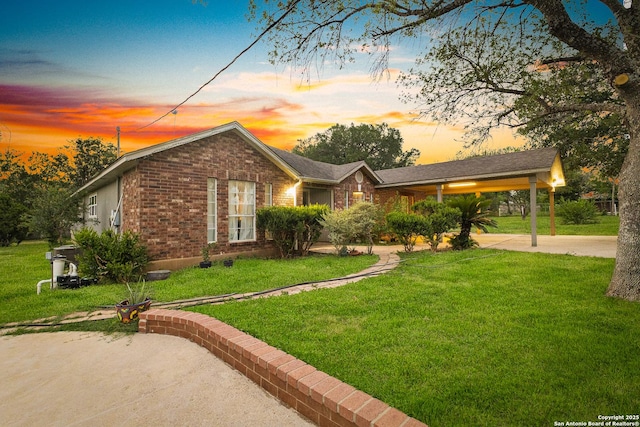 13040 Tomlynn, Atascosa, TX 78002 - view of front facade with brick siding, a lawn, and driveway
