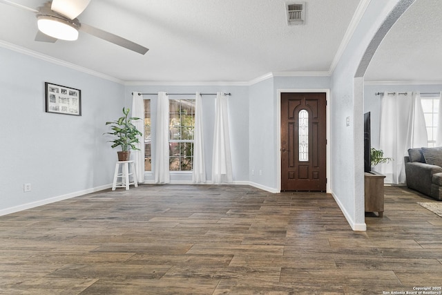 13040 Tomlynn, Atascosa, TX 78002 - foyer with arched walkways, crown molding, a ceiling fan, baseboards, and dark wood-type flooring