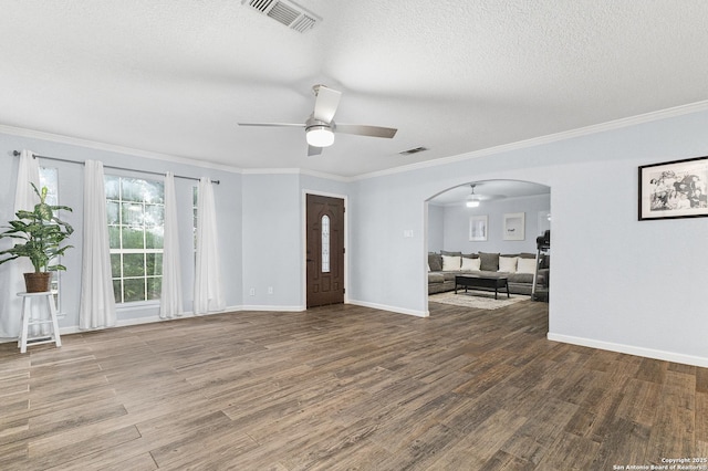13040 Tomlynn, Atascosa, TX 78002 - foyer with ceiling fan, wood finished floors, arched walkways, a textured ceiling, and crown molding