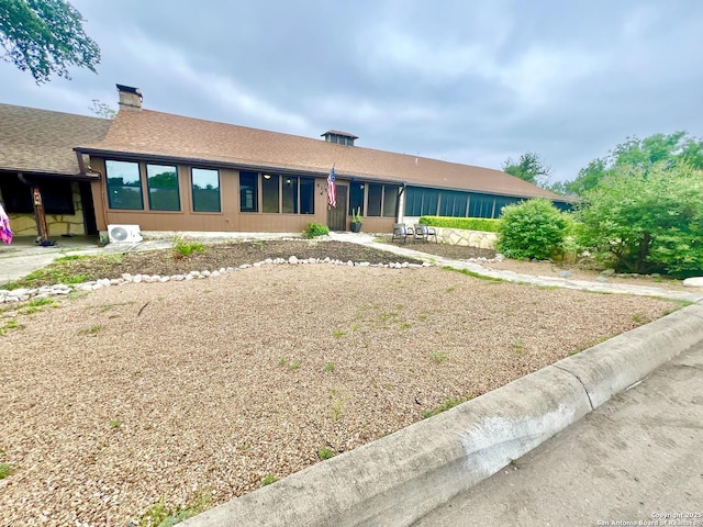 415 Fort Clark Rd Unit 21, Brackettville, TX 78832 - view of front facade featuring a chimney and a shingled roof