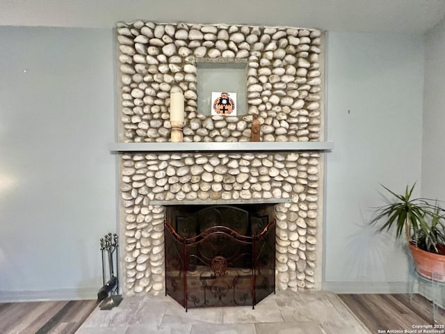 415 Fort Clark Rd Unit 21, Brackettville, TX 78832 - detailed view of baseboards, a fireplace with flush hearth, and wood finished floors