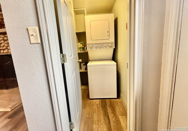 415 Fort Clark Rd Unit 21, Brackettville, TX 78832 - laundry room with stacked washing machine and dryer and wood finished floors