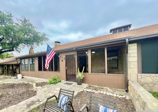 415 Fort Clark Rd Unit 21, Brackettville, TX 78832 - rear view of property with stone siding and a sunroom