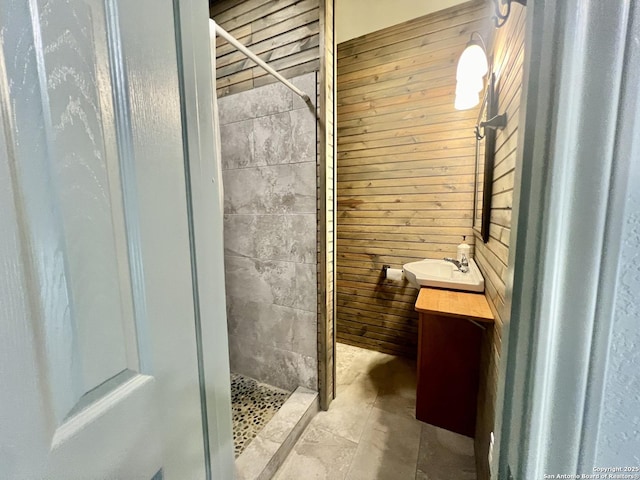 415 Fort Clark Rd Unit 21, Brackettville, TX 78832 - bathroom featuring wood walls, a stall shower, and vanity