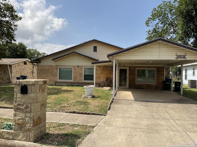 2918 Hatton, San Antonio, TX 78237 - view of front facade with a front yard, concrete driveway, an attached carport, central AC unit, and stone siding