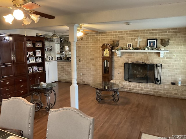 2918 Hatton, San Antonio, TX 78237 - living area featuring a ceiling fan, wood finished floors, a fireplace, and brick wall