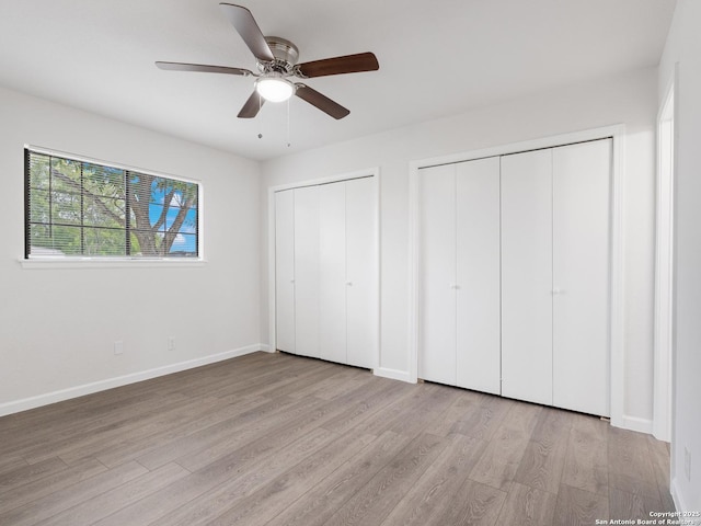 13306 Chesterton, San Antonio, TX 78217 - unfurnished bedroom featuring two closets, wood finished floors, and a ceiling fan