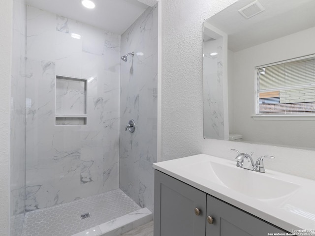 13306 Chesterton, San Antonio, TX 78217 - full bathroom with vanity, a marble finish shower, and a textured wall