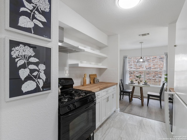 13306 Chesterton, San Antonio, TX 78217 - kitchen with black gas range, wall chimney range hood, decorative backsplash, butcher block counters, and white cabinets