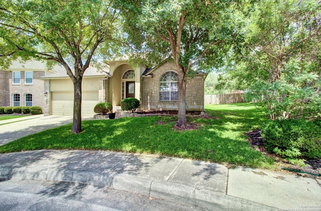 27123 Trinity Woods, San Antonio, TX 78261 - view of front of property with stone siding, a garage, driveway, and stucco siding