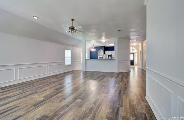 27123 Trinity Woods, San Antonio, TX 78261 - unfurnished living room featuring a ceiling fan, plenty of natural light, dark wood-style flooring, wainscoting, and vaulted ceiling