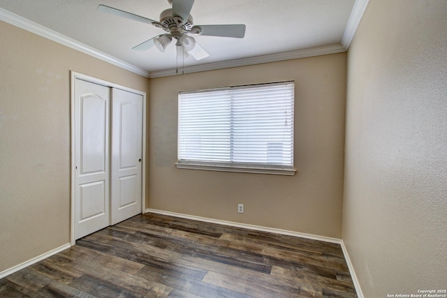 27123 Trinity Woods, San Antonio, TX 78261 - unfurnished bedroom with crown molding, a closet, dark wood-style floors, baseboards, and a ceiling fan