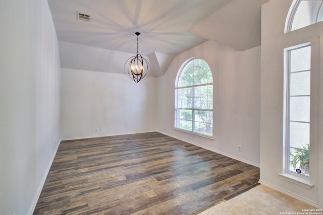 27123 Trinity Woods, San Antonio, TX 78261 - spare room featuring a chandelier, wood finished floors, vaulted ceiling, and baseboards