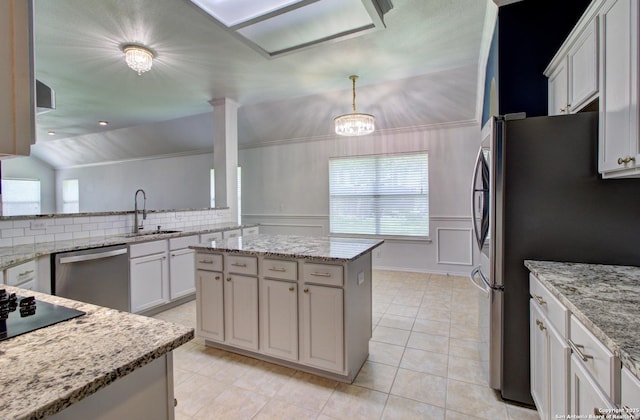 27123 Trinity Woods, San Antonio, TX 78261 - kitchen with appliances with stainless steel finishes, a sink, a kitchen island, light stone countertops, and hanging light fixtures