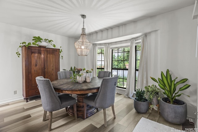 3105 Pecan Valley Dr, Temple, TX 76502 - dining area with a chandelier, light wood-type flooring, and baseboards