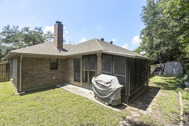 3105 Pecan Valley Dr, Temple, TX 76502 - back of house with brick siding, a chimney, a yard, and a sunroom